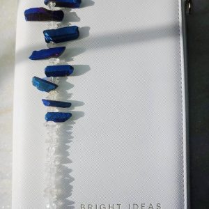 Venus bookmark from Inanna Joy Boutique, handcrafted with deep blue crystal quartz and clear gemstone chips, styled on a white "Bright Ideas" journal cover.