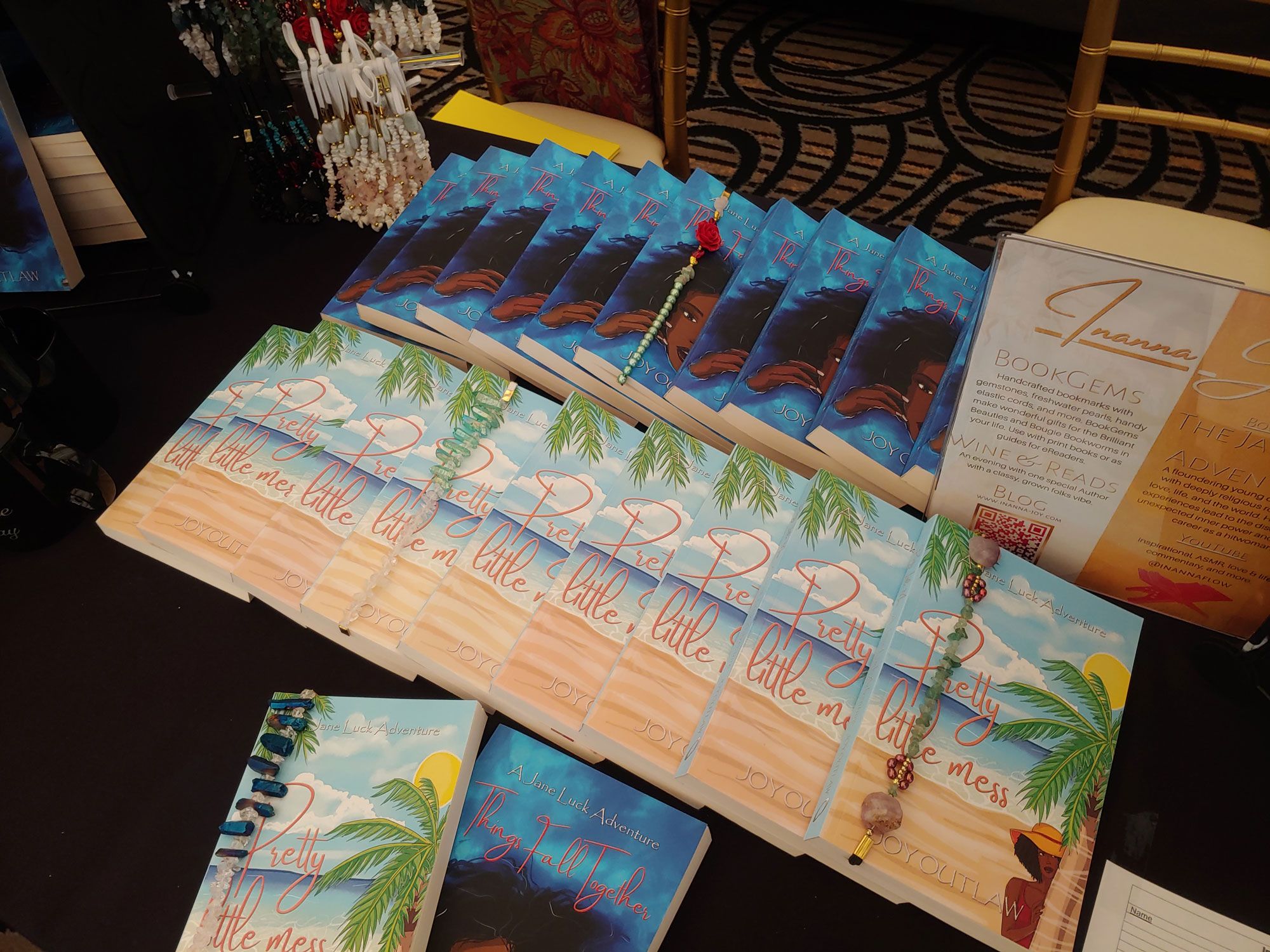 Display of Inanna Joy’s book “Pretty Little Mess” with bookmarks on a vendor table.